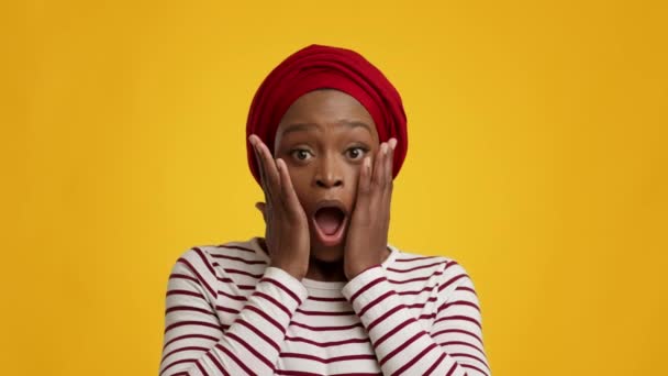 Shocked Black Female Looking At Camera Touching Face, Yellow Background — Stock Video