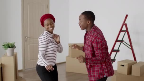 Happy African American Couple Dancing Having Fun Celebrating Moving House — Stok Video