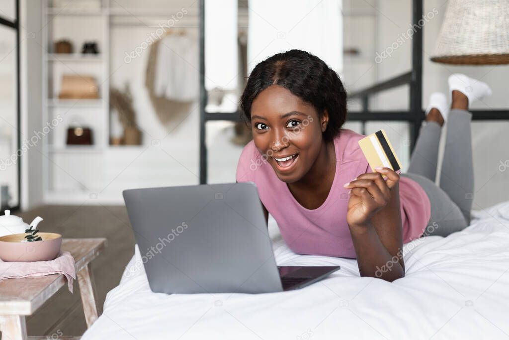 Black Female Showing Credit Card Shopping On Laptop At Home