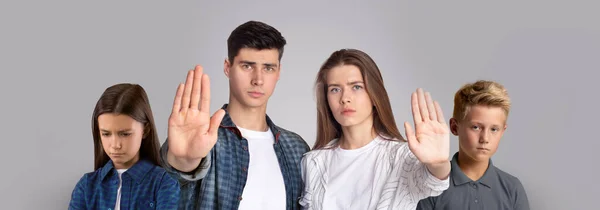 Young Couple With Little Children Showing Stop Gesture At Camera — Stock Photo, Image