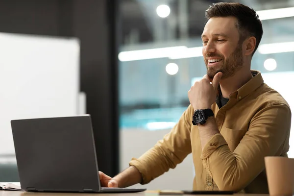 Glücklicher Geschäftsmann mit Laptop, der online arbeitet, sitzt im Büro — Stockfoto