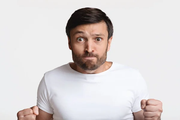 Angry Man Clenching Fists Looking At Camera Over White Background — Stok Foto