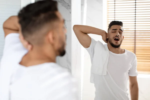 Lazy Morning. Portrait Of Sleepy Young Arab Man Yawning In Bathroom