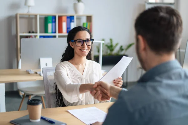 Glimlachende vrouwelijke personeelsmanager en sollicitant schudden handen na succesvol sollicitatiegesprek op kantoor — Stockfoto