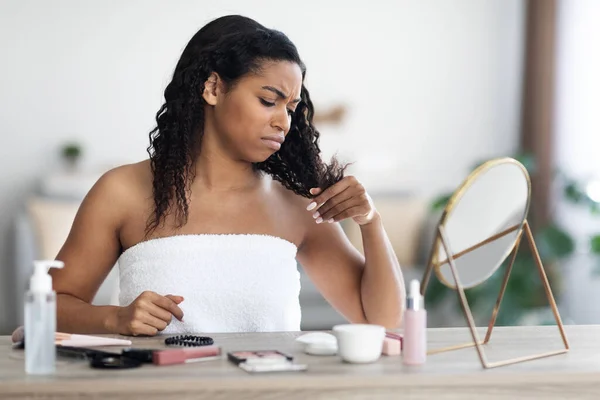 Wanita muda african american marah memeriksa rambutnya — Stok Foto
