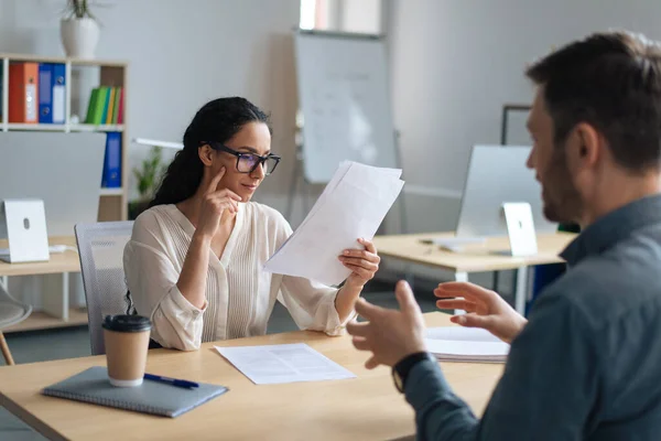 Personalchef som kommunicerar med den lediga kandidaten, läser CV under anställningsintervjun på kontoret — Stockfoto