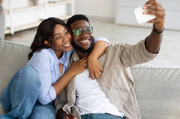 Portret szczęśliwej czarnej pary robiącej sobie selfie w domu — Zdjęcie stockowe