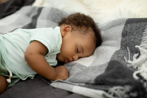 Afro-americano bebê menino dormindo no lado deitado na cama — Fotografia de Stock