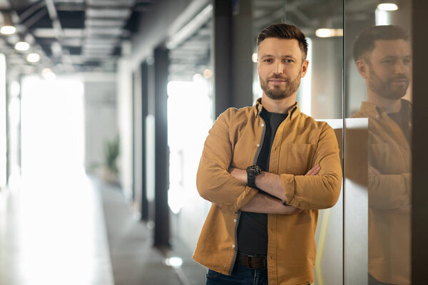 Confident Businessman Crossing Hands Posing Standing In Doorway In Office