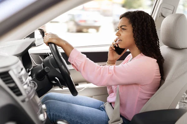 Zwarte vrouw praten op mobiele telefoon tijdens het rijden auto — Stockfoto