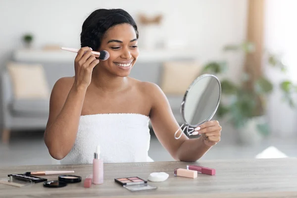 Pretty african american wanita dibungkus handuk memasang make up — Stok Foto