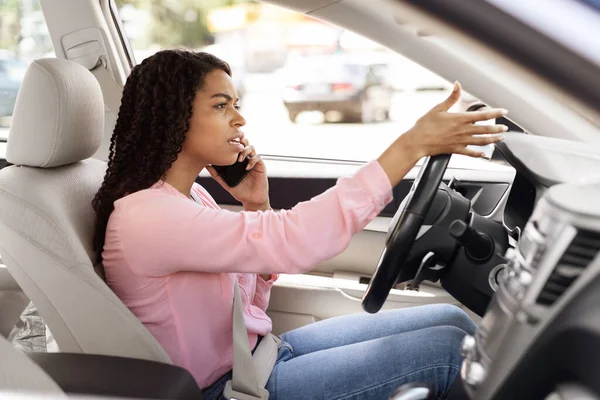 Boos zwarte vrouw praten op mobiele telefoon tijdens het besturen van de auto — Stockfoto