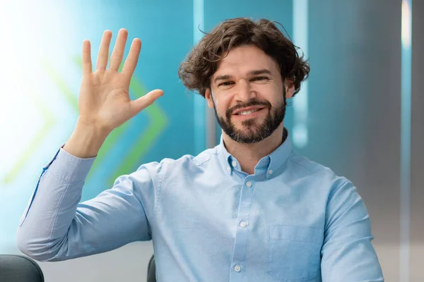 Greeting Concept. Smiling business man waving hand at camera — ストック写真