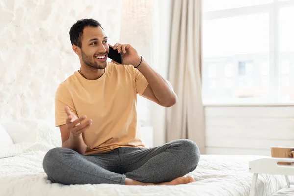 Arabic Man Talking On Mobile Phone Communicating Sitting In Bedroom — Foto de Stock