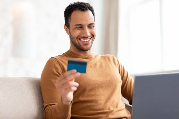 Veselý muž pomocí PC a kreditní karty doma — Stock fotografie