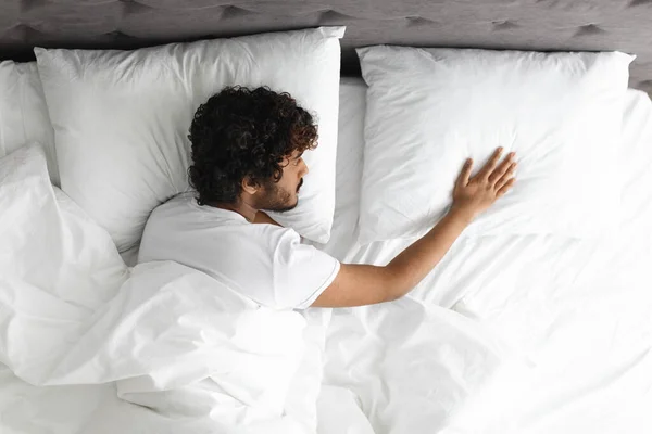 Top view of lonely guy touching pillow next to him —  Fotos de Stock