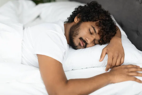 Closeup portrait of peaceful indian guy sleeping in bed — Stok fotoğraf