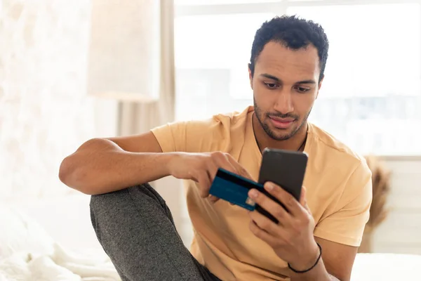 Arabic Man Shopping Online Via Cellphone And Credit Card Indoor — Foto de Stock