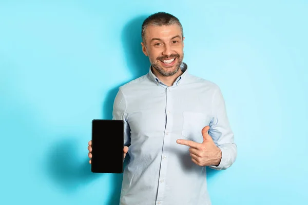 Middle Aged Man Showing Digital Tablet Blank Screen, Blue Background — Stockfoto