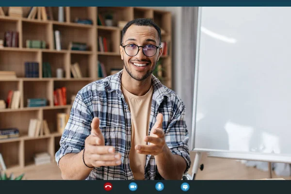 Virtual tutoring concept. Arab male teacher having video call, teaching foreign languages remotely from home — Stock Photo, Image