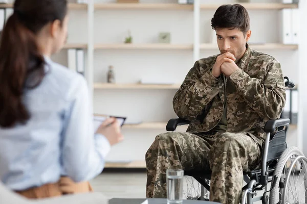 Depressed disabled soldier in wheelchair visiting psychologist — Stock Fotó