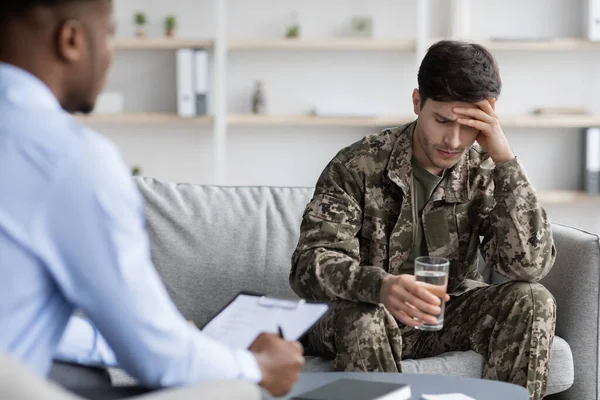 Üzgün asker psikoterapistle konuşuyor.