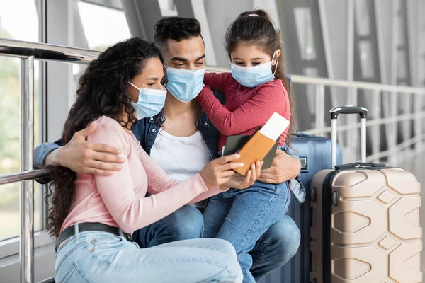 Middle Eastern Family Of Three Wearing Medical Masks Waiting Flight At Airport — стоковое фото