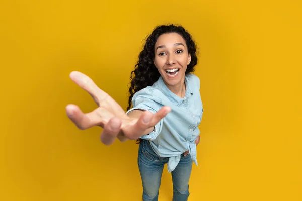 Excited young woman outstretching hand, trying to grab something — Stockfoto