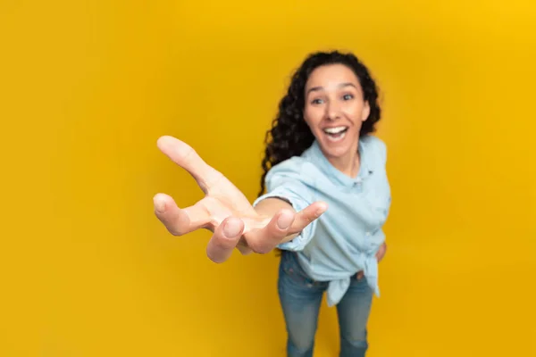 Excited young woman outstretching hand, trying to reach something — Stockfoto