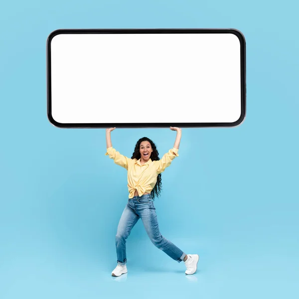 Excited lady holding heavy white empty smartphone screen — Stok fotoğraf