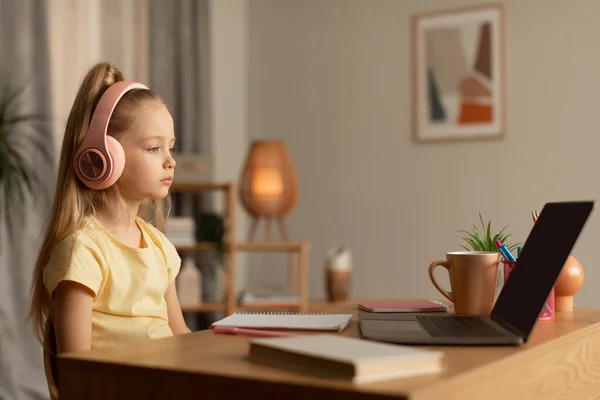 Little Girl Looking At Laptop Wearing Earphones Learning Online Indoors — Stock fotografie