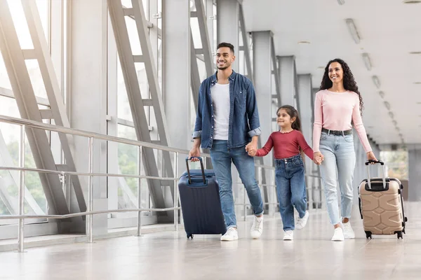 Happy Middle Eastern Family Of Three Walking With Suitcases At Airport Hallway — 스톡 사진