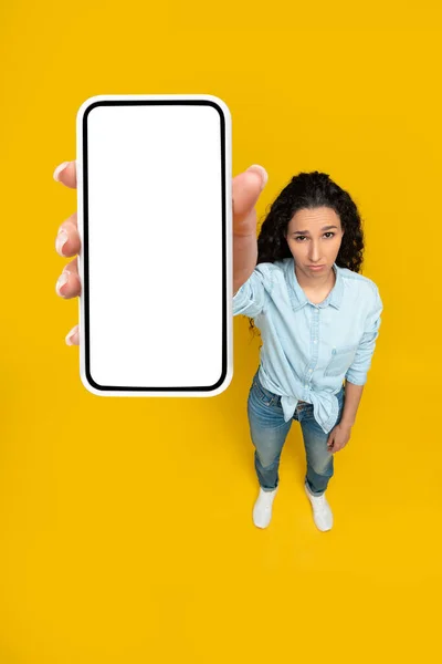 Sad lady holding showing empty smartphone screen