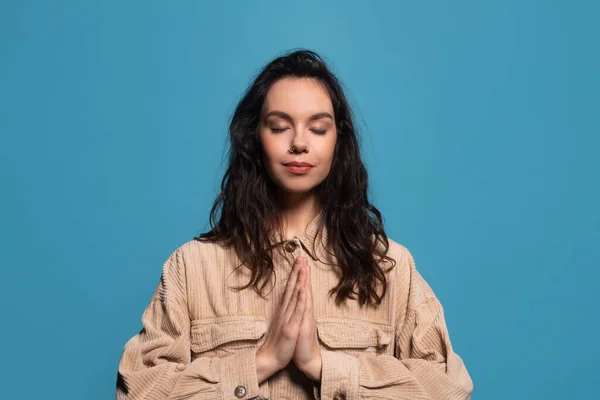 Γαλήνια ηρεμία νεαρή ευρωπαϊκή μελαχρινή γυναίκα σε casual με κλειστά μάτια προσεύχεται ή διαλογισμό — Φωτογραφία Αρχείου