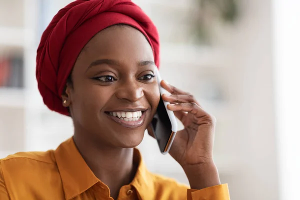 Closeup portrait of pretty muslim black woman talking on phone — стоковое фото