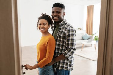 Cheerful African American Couple Opening Door Of Their House