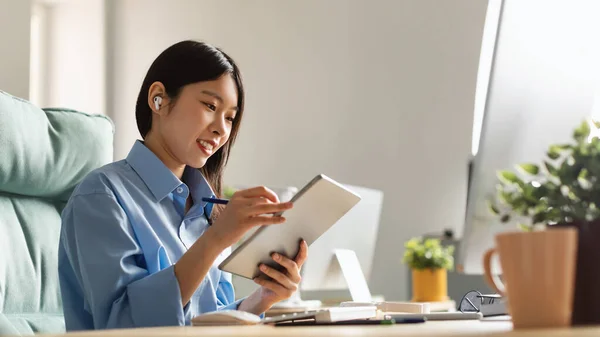 Portrait Of Female Asian Designer Using Tablet