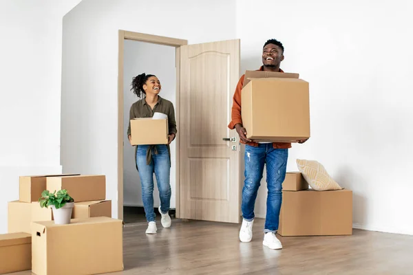 Joyful African American Couple Coming Into House Carrying Moving Boxes — Fotografia de Stock
