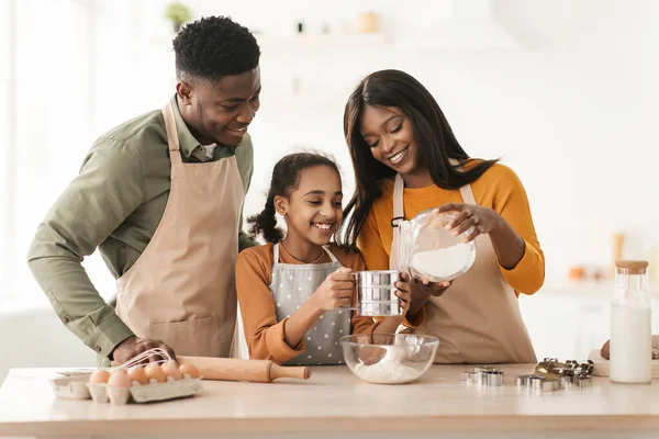 Happy Black Family Sifting Flour Baking Making Dough In Kitchen