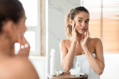 Woman Touching Face Caring For Perfect Smooth Skin In Bathroom