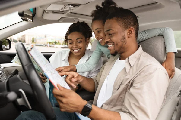 목적지를 선택하는 자동차 안에 앉아 있는 행복 한 아프리카 가족 의행 복 한 지도 — 스톡 사진