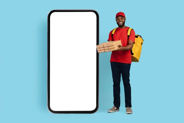 Smiling Black Male Courier Holding Pizza Boxes While Standing Near Blank Smarthone — Stock Photo, Image