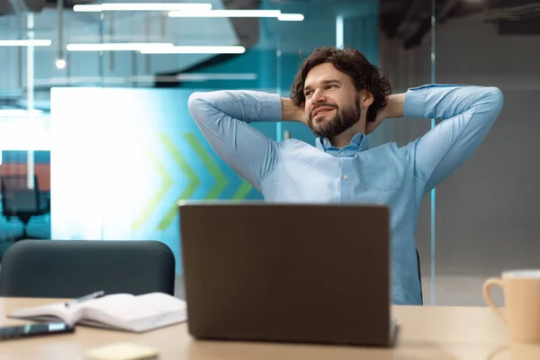 Portrait of smiling business man relaxing on chair at office