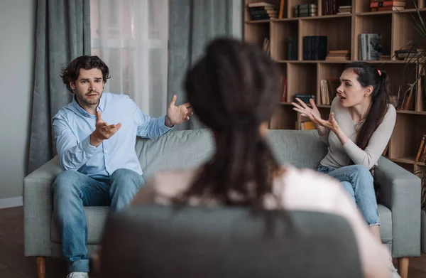 Young african american lady psychologist consults unhappy emotional european couple, husband and wife quarrel — Stock Photo, Image