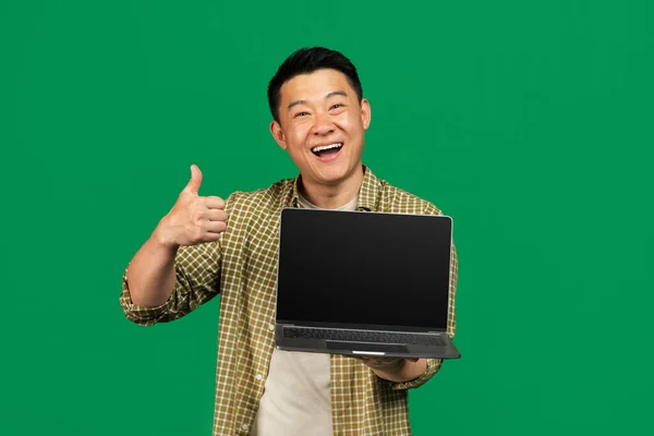 Happy Asian Mature Man Showing Laptop Empty Screen Gesturing Thumb — Stock Photo, Image