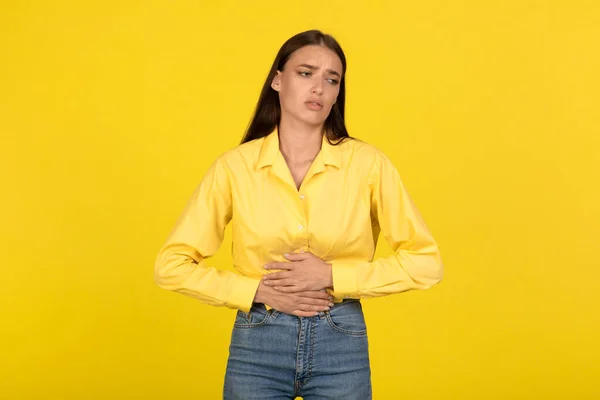 Unhappy Young Female Suffering Stomachache Touching Aching Abdomen Standing Yellow — Stock Photo, Image