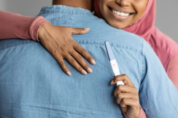 Černá Muslimka Hidžábu Drží Pozitivní Těhotenský Test Objímající Manžela Šťastná — Stock fotografie