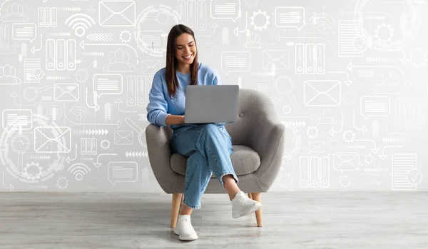 Young Female Freelancer Sitting On Chair With Laptop Against Wall With Abstract Media Icons, Smiling Woman Working Online On Computer, Enjoying Remote Work And Virtual Communication, Collage