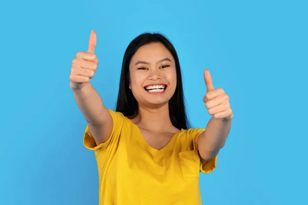 Portrait Happy Young Asian Lady Syndrome Yellow Shirt Showing Thumbs — Stockfoto