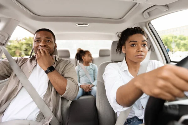 Scared Black Husband Biting Nails While Wife Driving Auto Having Danger Of Car Accident Sitting In New Automobile Inside. Family Riding Vehicle And Having Risk Of Crash. Transportation Concept